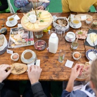 Visitors to HAUS-GARTEN-FREIZEIT enjoy the food on offer together at a lavishly laid table with a variety of breakfast items.