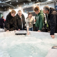 A group of 5 people try out a whirlpool. A group of 5 people try out a whirlpool.